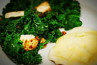 Marinaded, pan-seared tofu with kale and cheese-topped bread