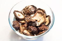 Place dried shiitake mushrooms in a medium-sized bowl and add water to cover. Rehydrate mushrooms until soft,  20 to 30 minutes (or according to instructions). Set aside.